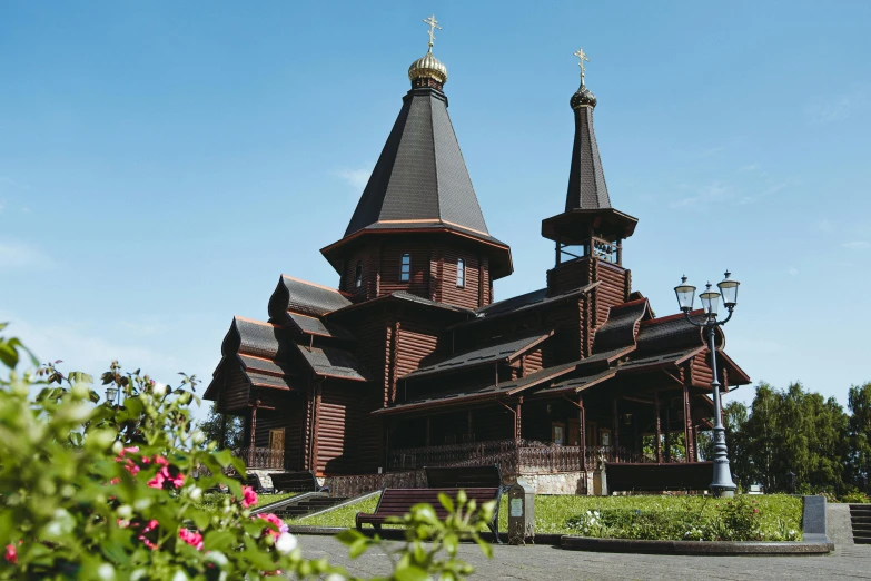 a wooden church with multiple towers sitting on the side