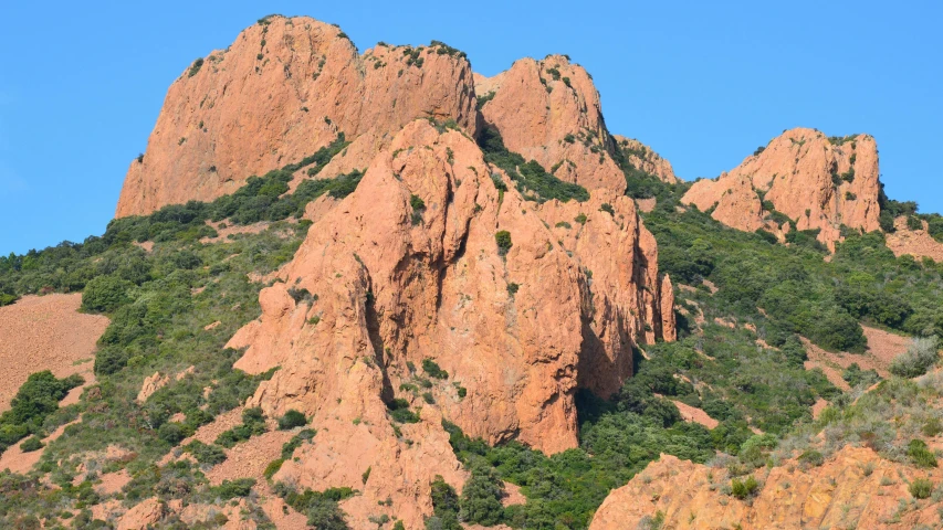 the top of some big mountain formations with vegetation