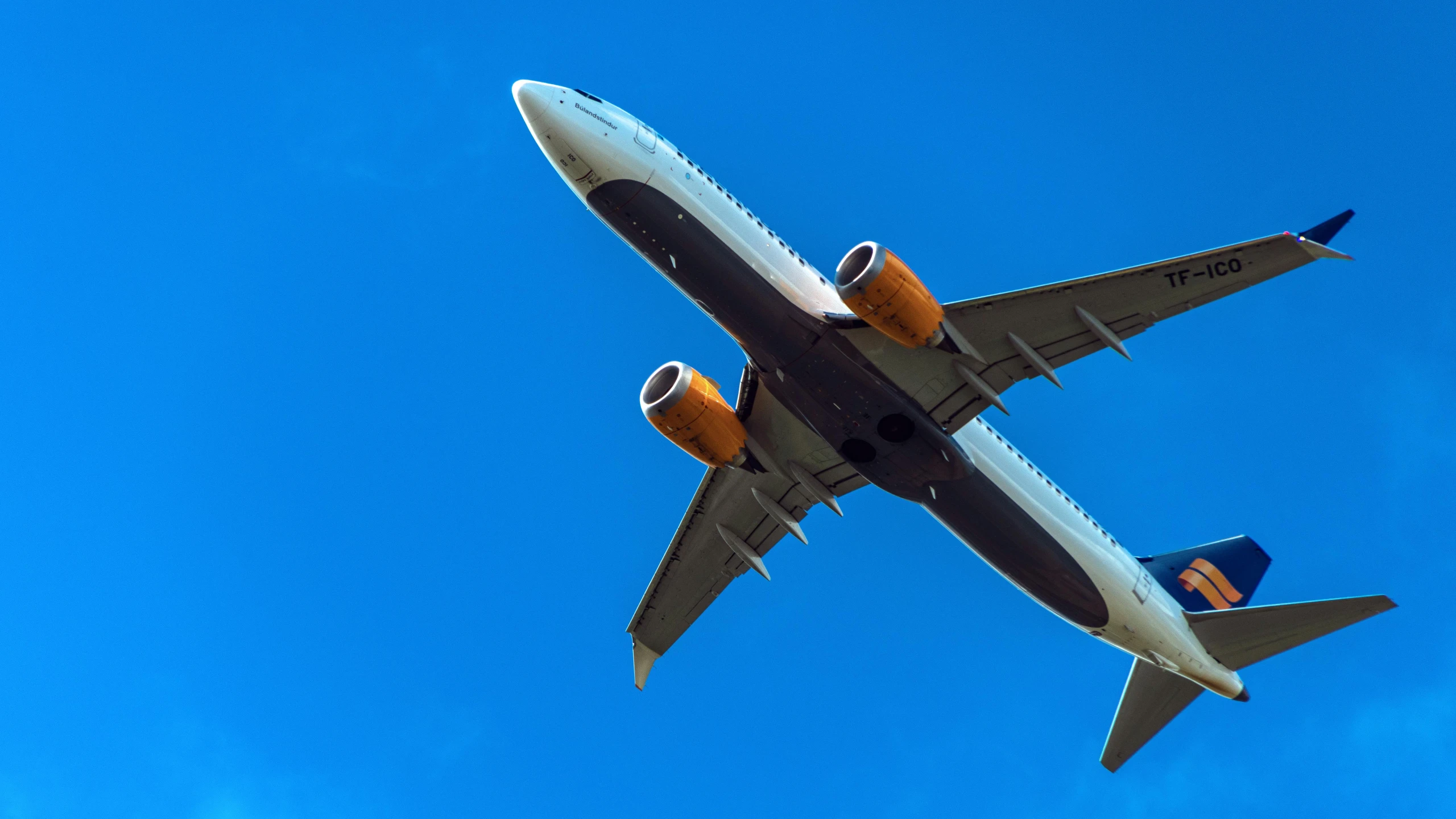 the underside of a passenger jet in the sky