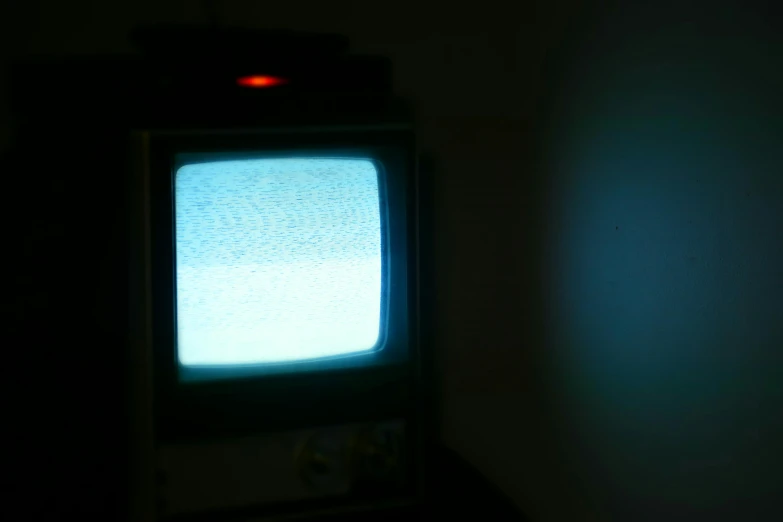 an old style television sitting against a wall