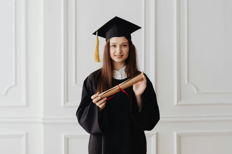 a female student is holding her diploma