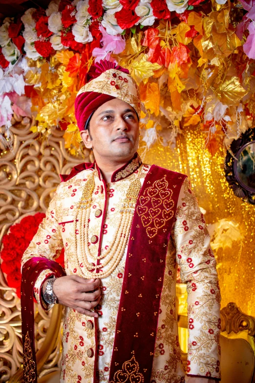 a man dressed in an asian garb poses for the camera