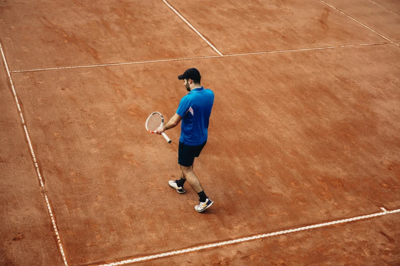 a man standing on top of a tennis court holding a racquet