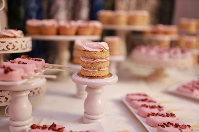 the cakes on the table are covered with icing