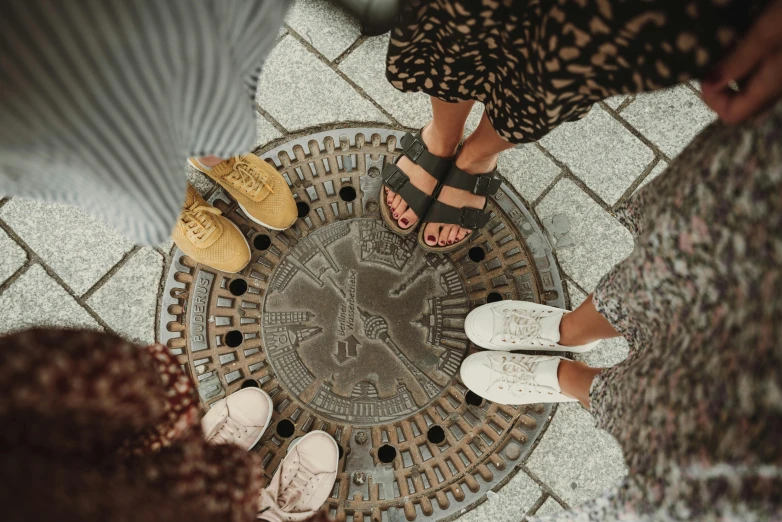 a group of people standing on top of a sidewalk