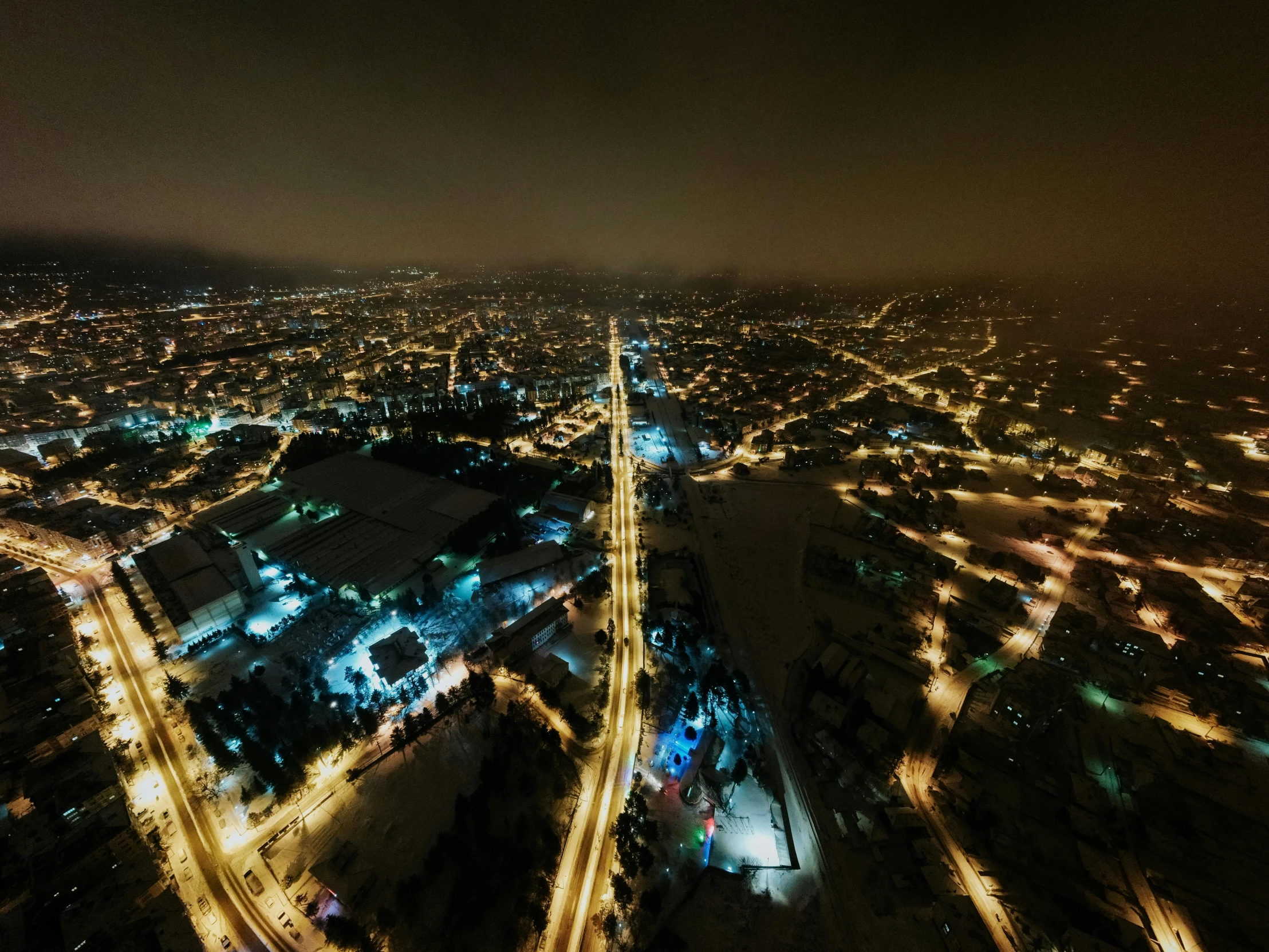 the lights of city buildings light up the night sky