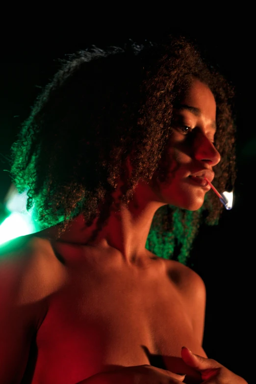 woman smoking in dark lit room at night