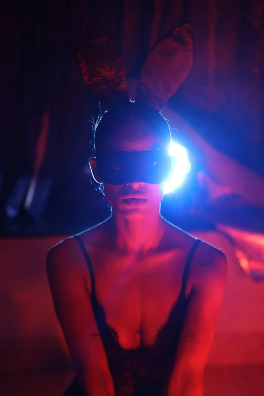 a woman wearing blindfolds stands on the runway