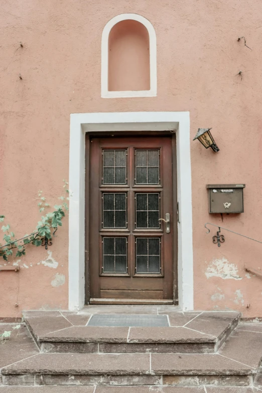 a front door and steps next to an entrance