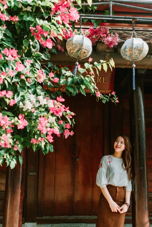 a woman is standing outside of the building