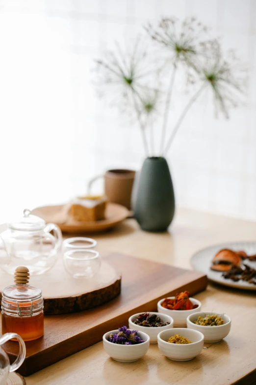 a wooden table topped with bowls of food