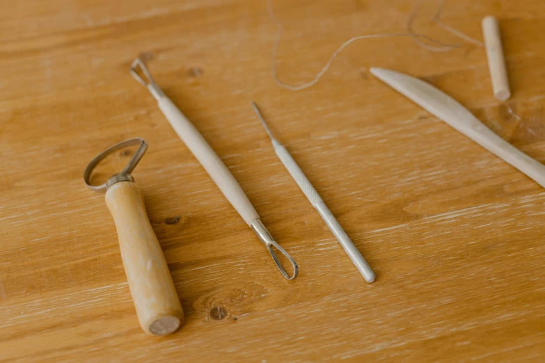 a table with wooden pegs and some crochets on it