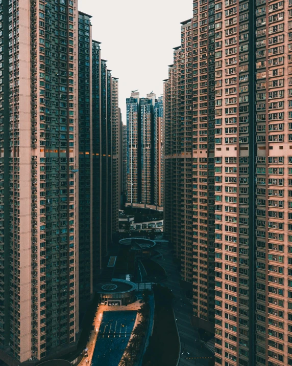 tall brown building in the distance surrounded by high rise apartments