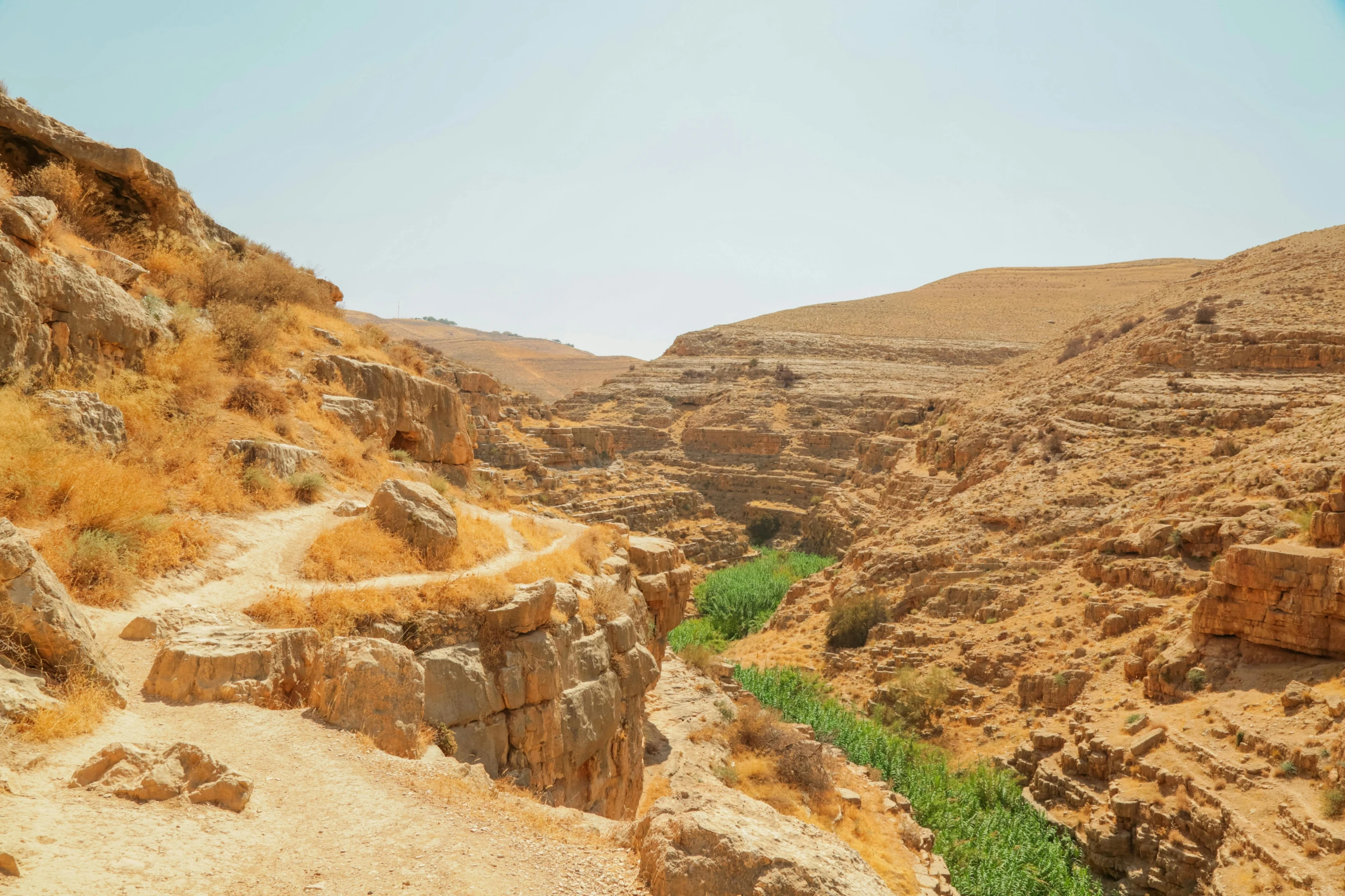 a view looking down at a dry rocky valley