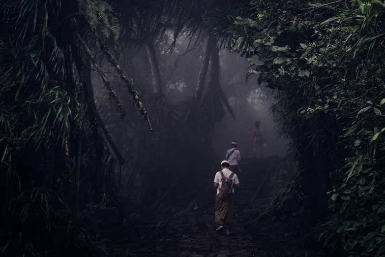 a man is hiking through some very thick trees