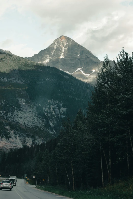 a mountain is shown as the sun sets on a road