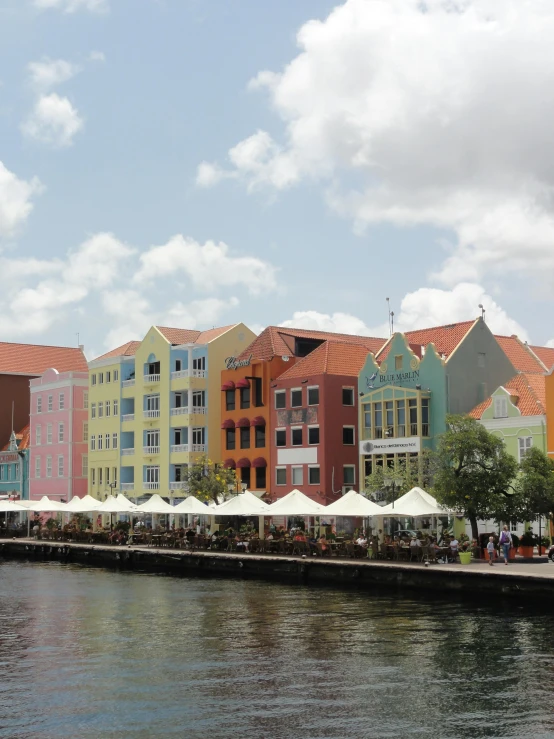 the buildings along the river are all different colored