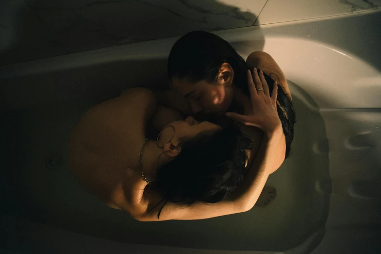 a man and woman emcing in a tub