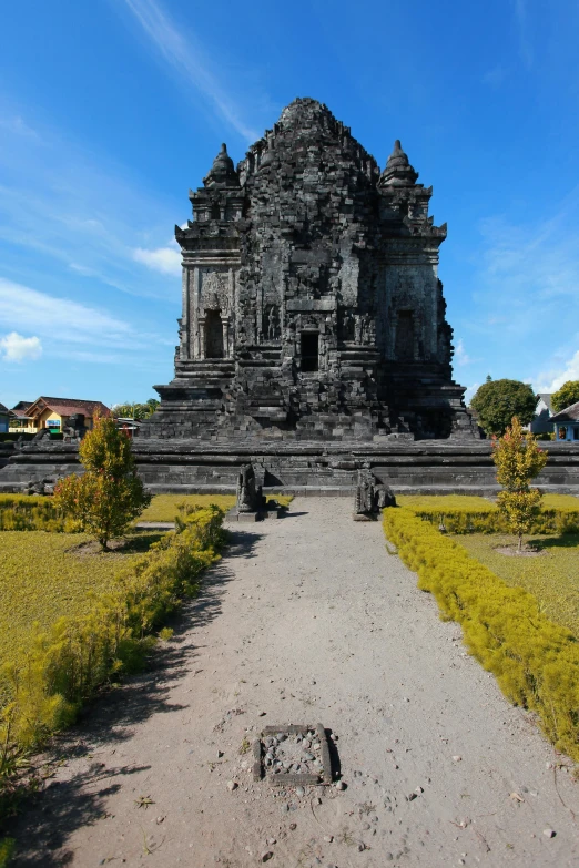 a large building sitting on top of a lush green field