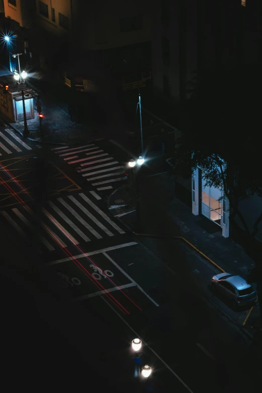 a city street with cars parked at a bus stop