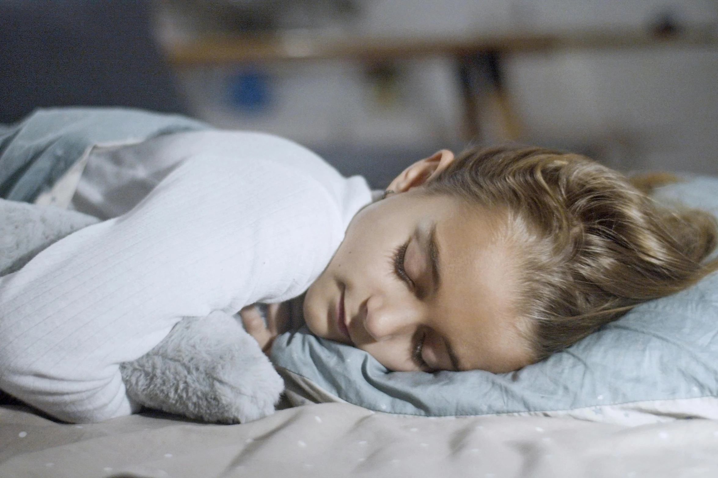 a young woman is sleeping on her bed