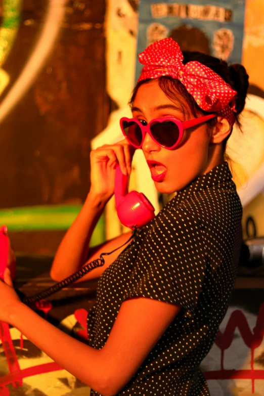 a girl is talking on a telephone outside