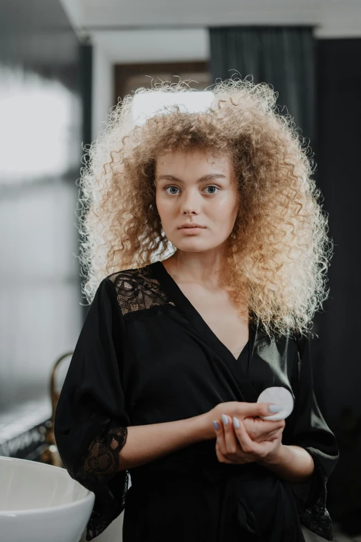 a woman with long blonde hair holding soing