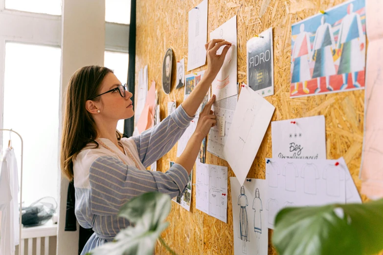 a woman at a work station setting up various office notes