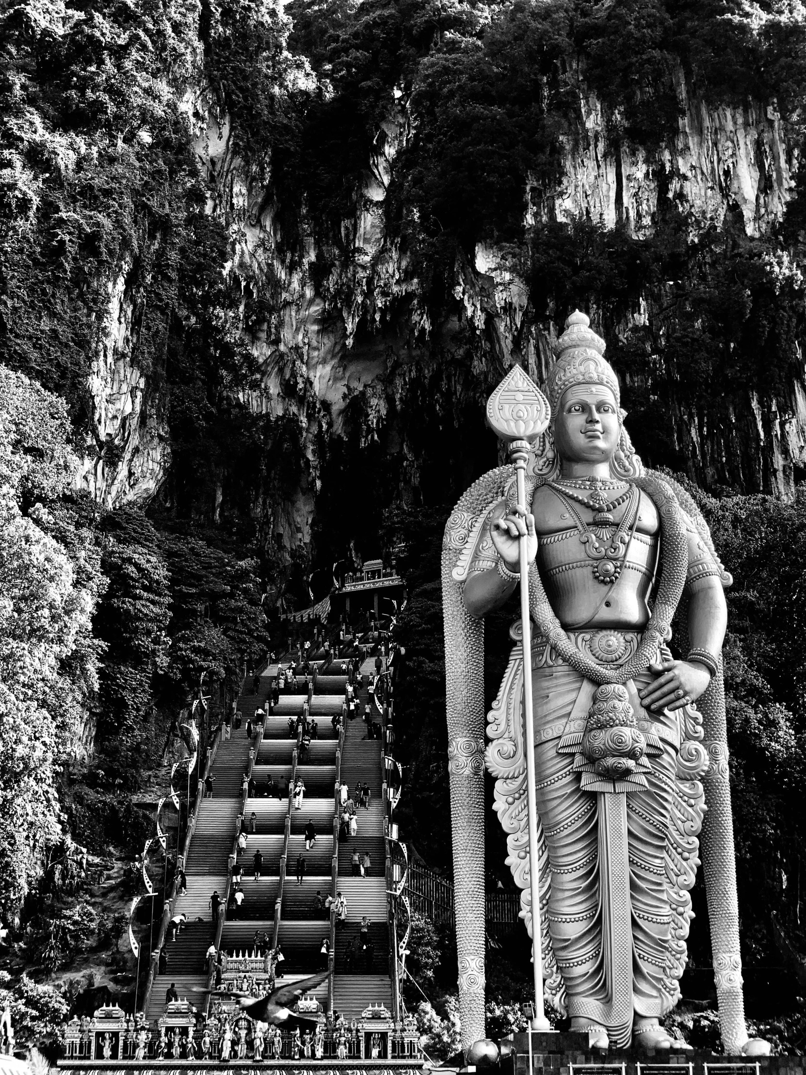 an idol sitting at the edge of a hill