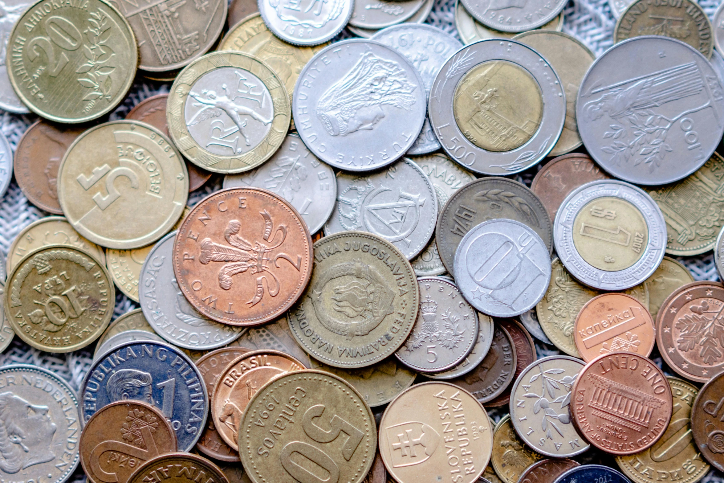 a pile of different colored coins