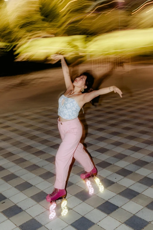 a woman with a pair of roller blades is spinning around