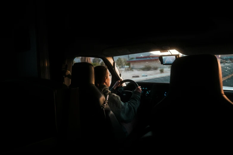 people in cars driving on an overcast day