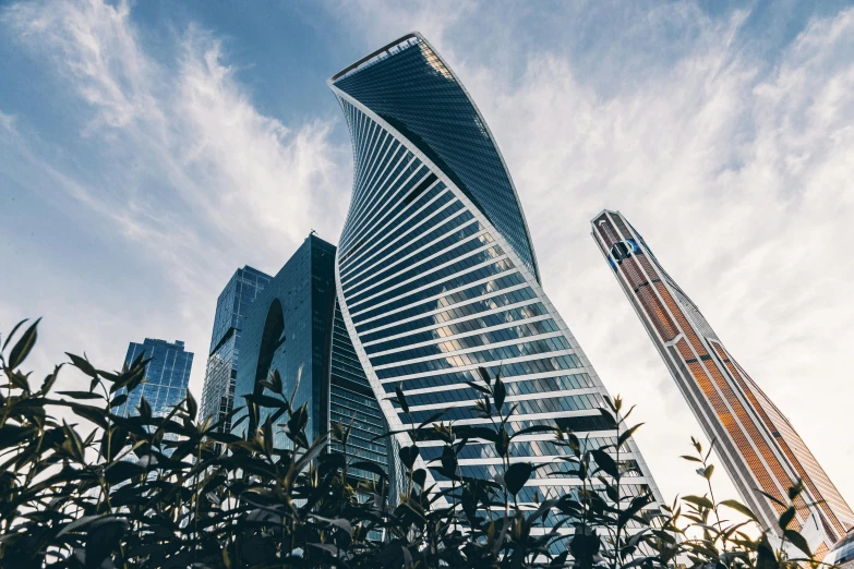 a tall building sitting next to a tall skyscr