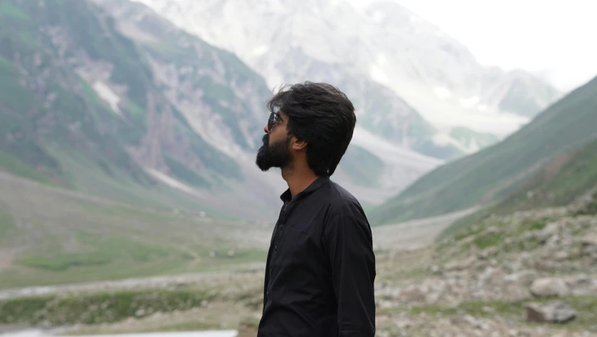 a man in a black shirt in a valley