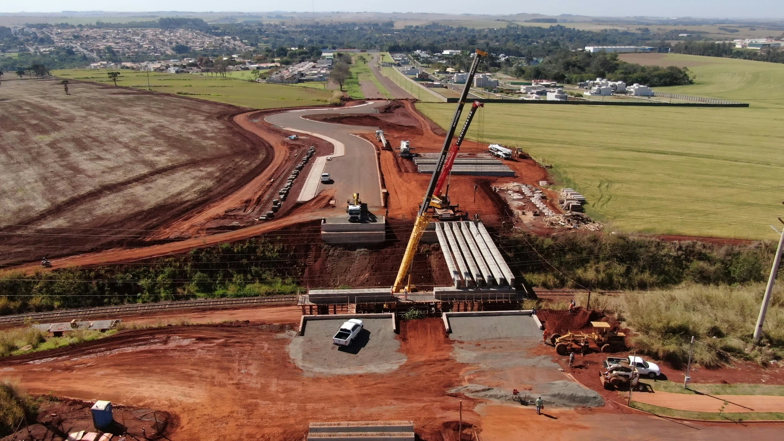 two cranes are lifting concrete into place at a construction site