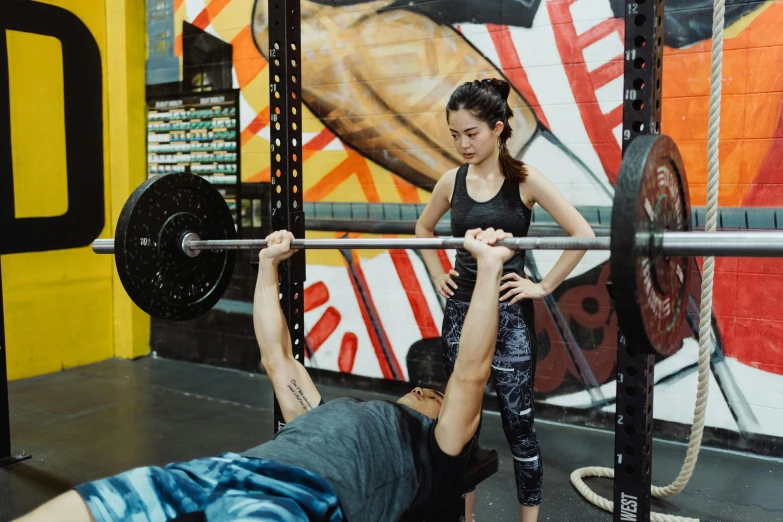 a person is doing an overhead squat with a barbell