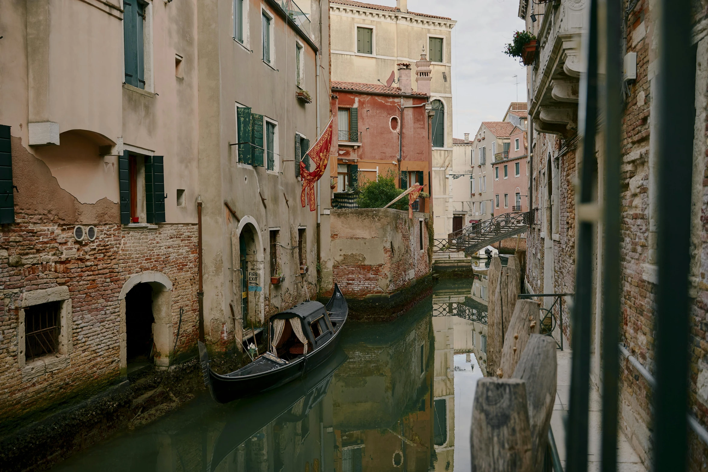 some people in a small boat moving along the canal