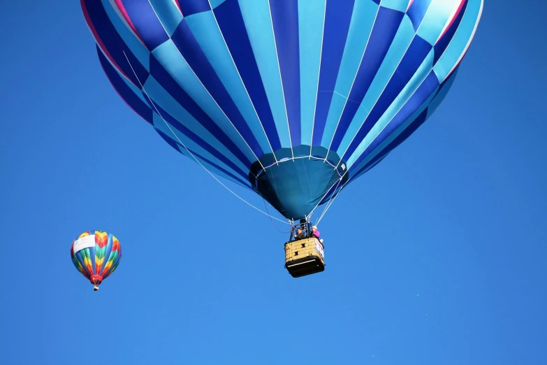 there are two  air balloons floating in the air