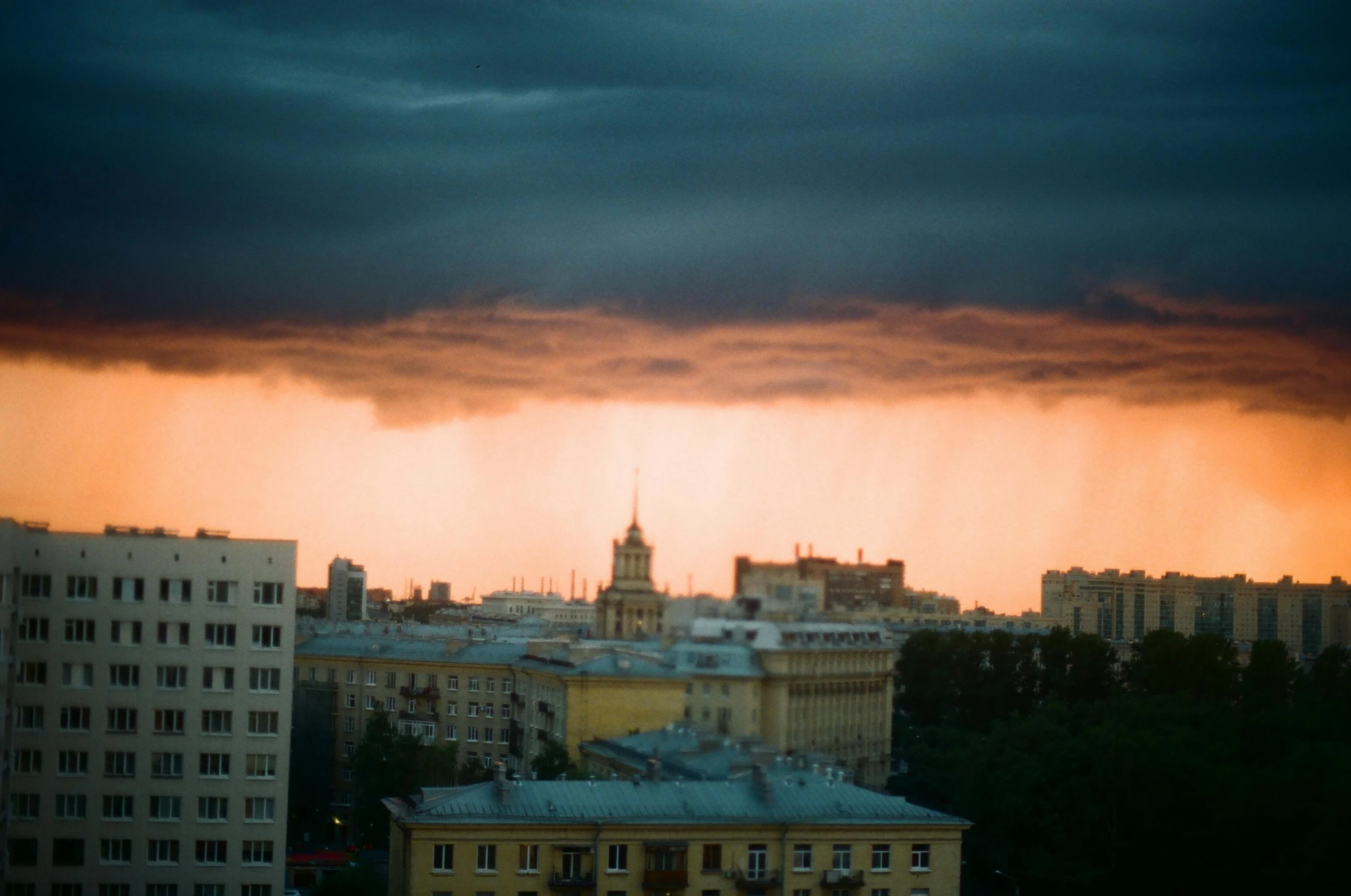 the clouds and buildings in the city are dark