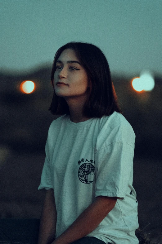 a girl is sitting on the ground looking up