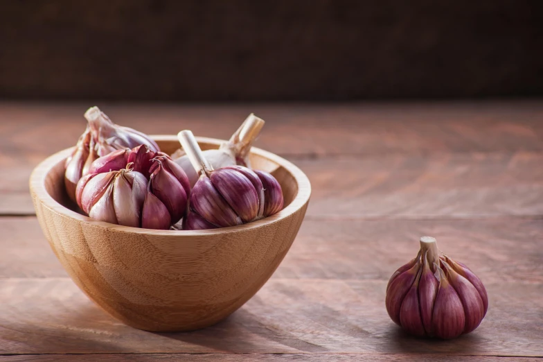 a wooden bowl with onions in it