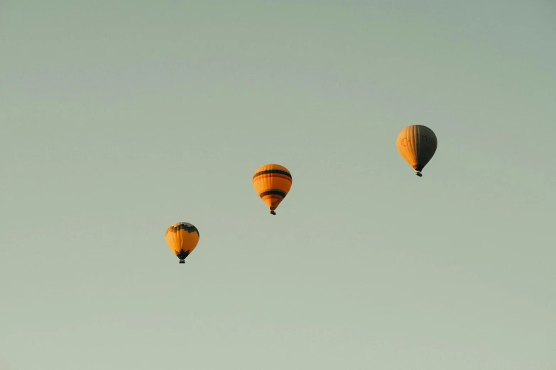 three  air balloons against a clear blue sky