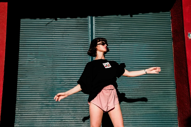 a woman is posing outside with a skateboard