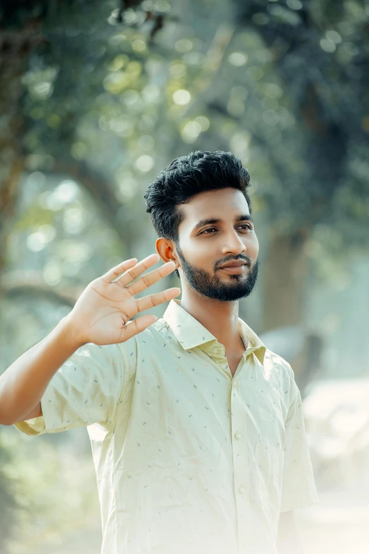 a man with an orange ring holding it's hand in the air