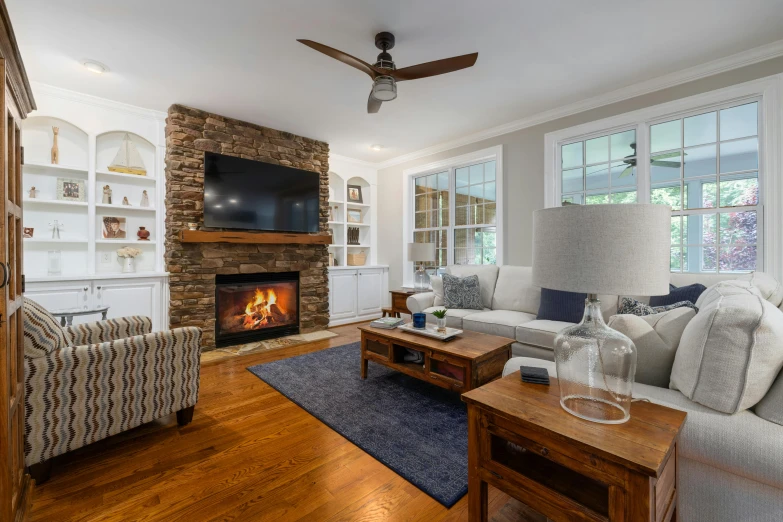 living room with fireplace, tv and seating area