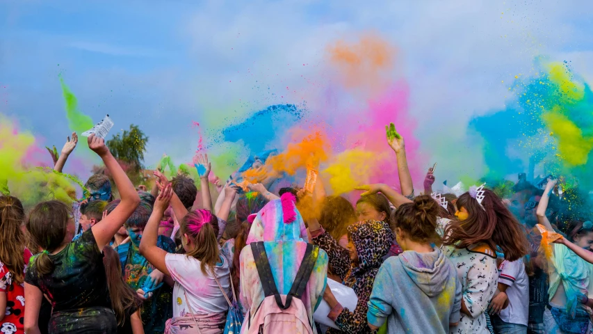 the crowd is smeared with colored powder to make a colorful walk