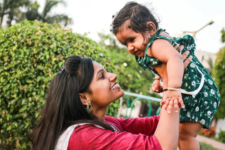 a woman holding a baby in her arms