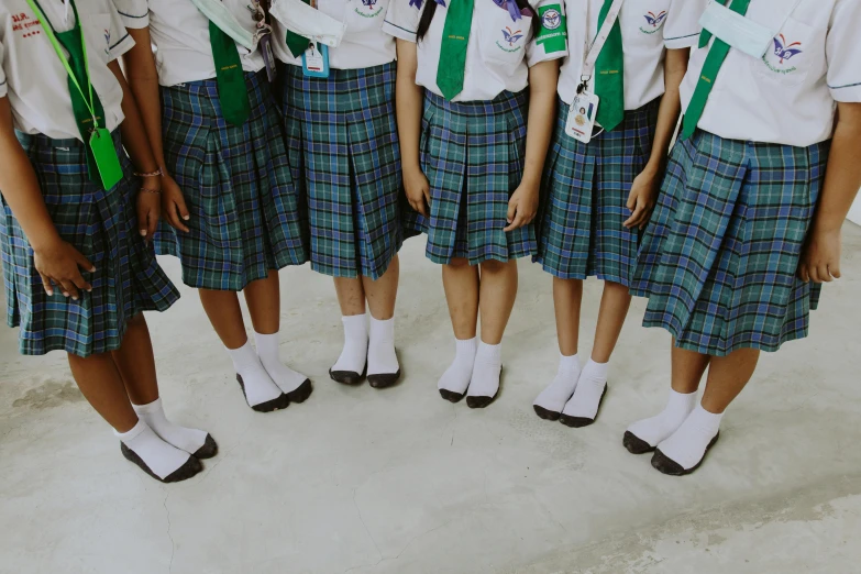 there are ten female schoolgirls with their skirts up