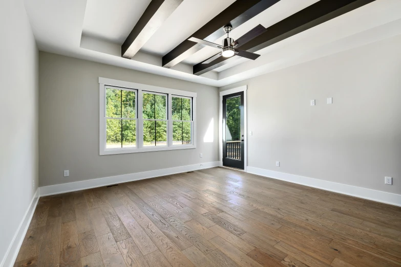 the living room has white walls and hardwood floors