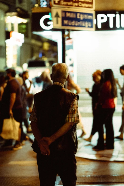 a man is standing alone in a busy area